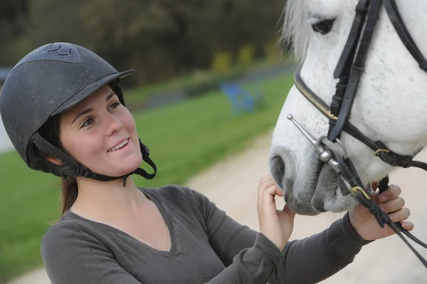   Woman playing with her horse — Stock fotografie